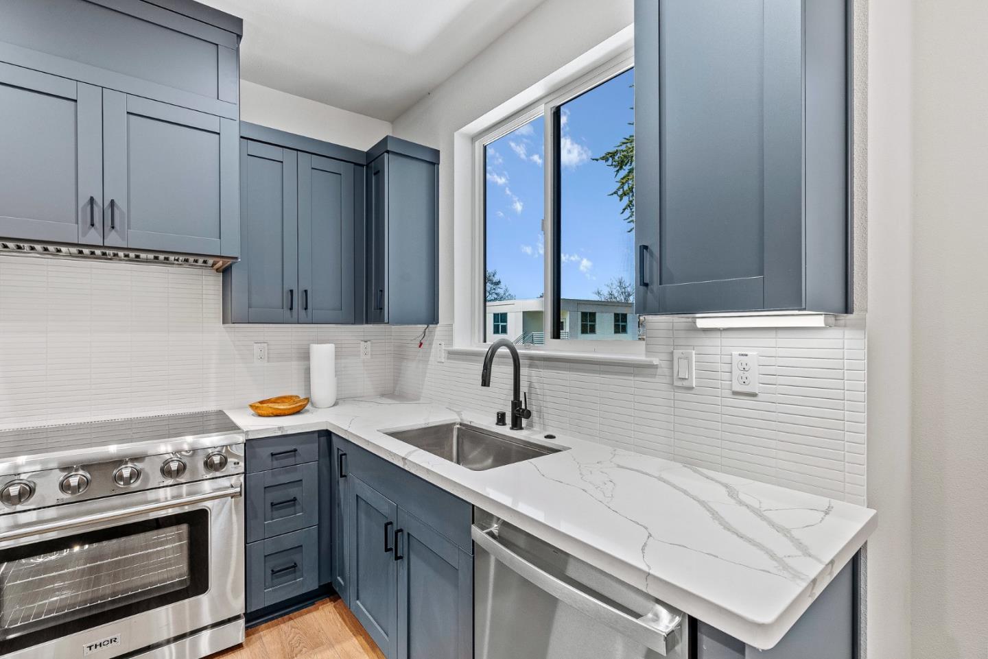 943 Woodside Road Redwood City, CA 94061 - Photo 11 of 19 a kitchen with a sink stove and cabinets