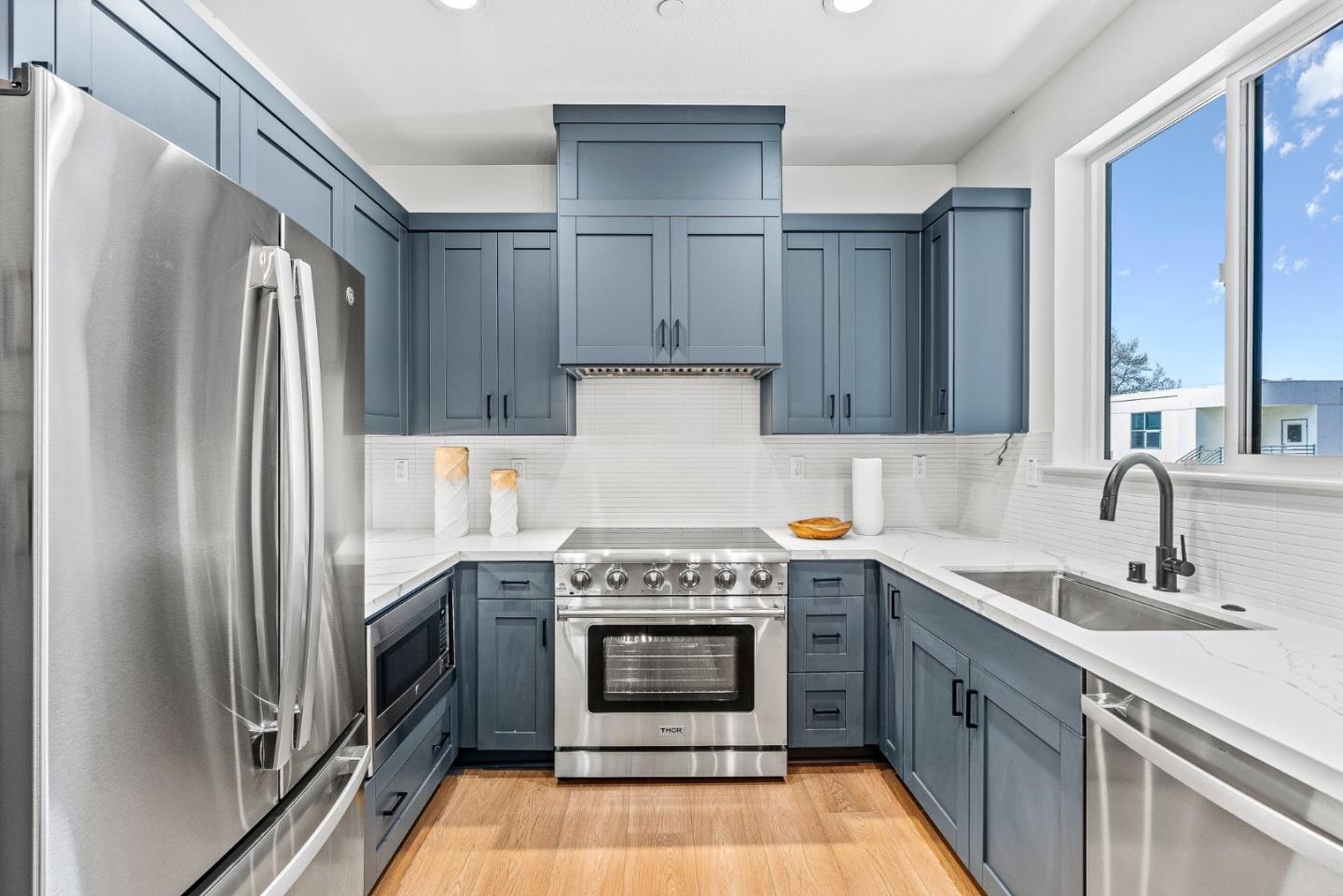 943 Woodside Road Redwood City, CA 94061 - Photo 12 of 19 a kitchen with a stove top oven and refrigerator