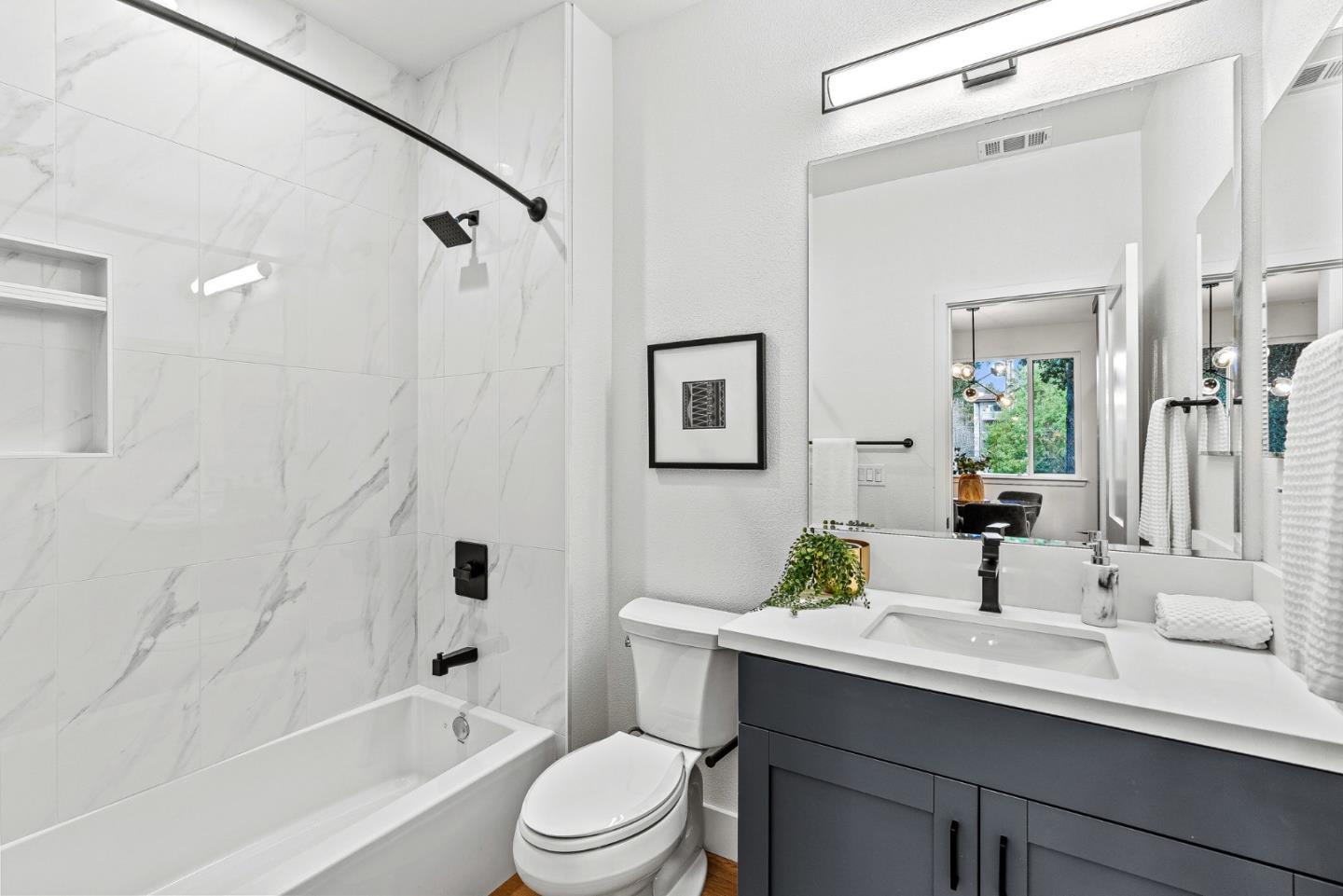 943 Woodside Road Redwood City, CA 94061 - Photo 13 of 19 a bathroom with a sink a toilet and shower