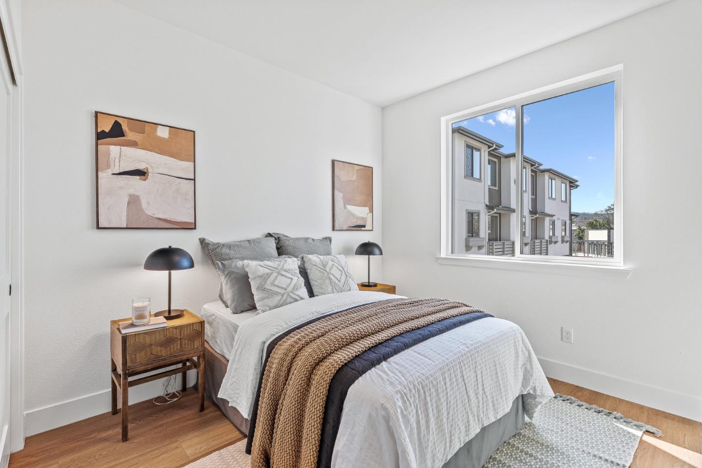 943 Woodside Road Redwood City, CA 94061 - Photo 14 of 19 a bedroom with a bed and a lamp on dresser with wooden floor