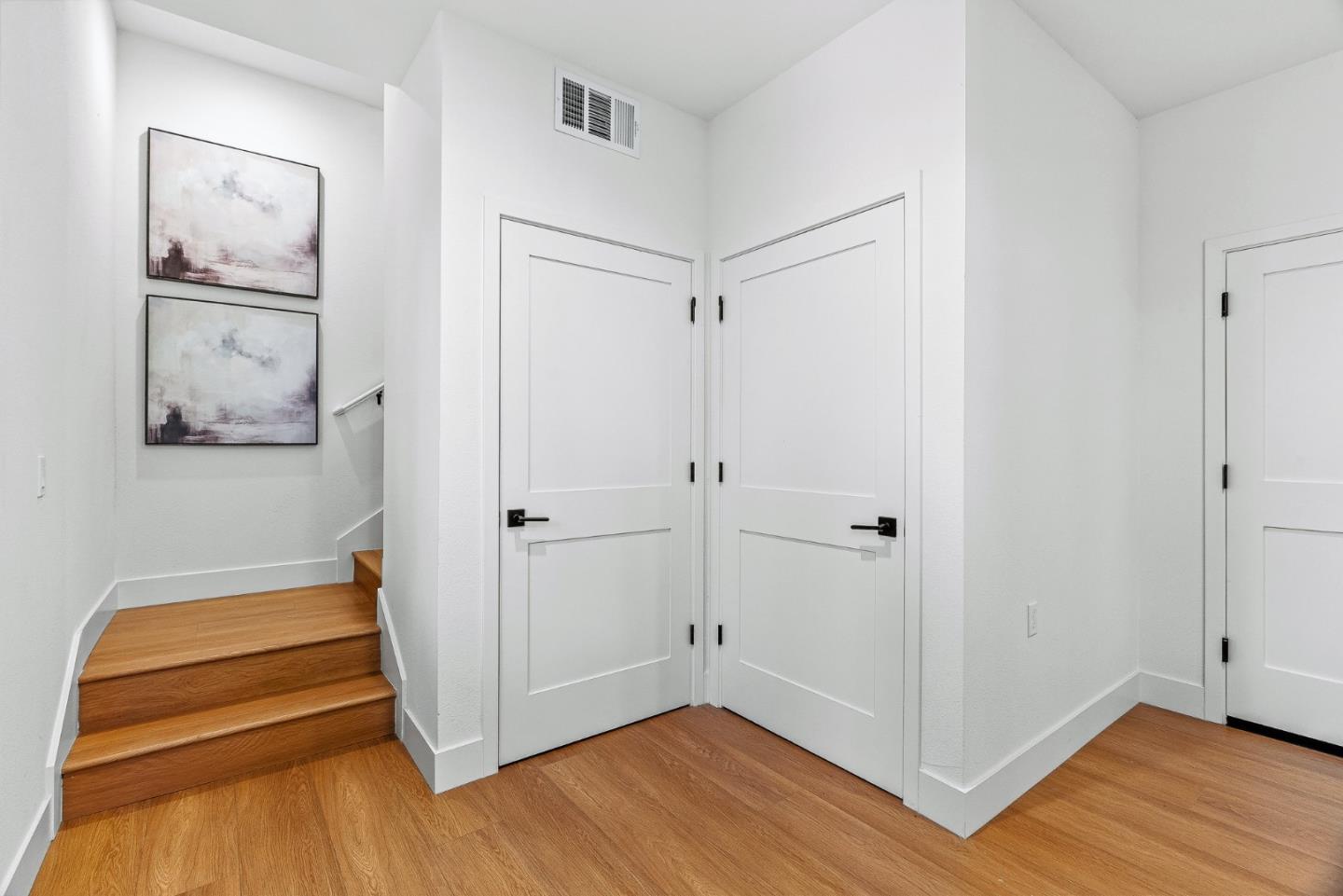 943 Woodside Road Redwood City, CA 94061 - Photo 3 of 19 a view of a hallway with wooden floor and closet
