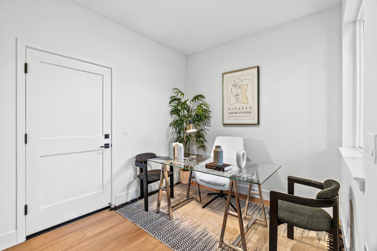 943 Woodside Road Redwood City, CA 94061 - Photo 4 of 19 a view of a workspace room with wooden floor wooden table and chair