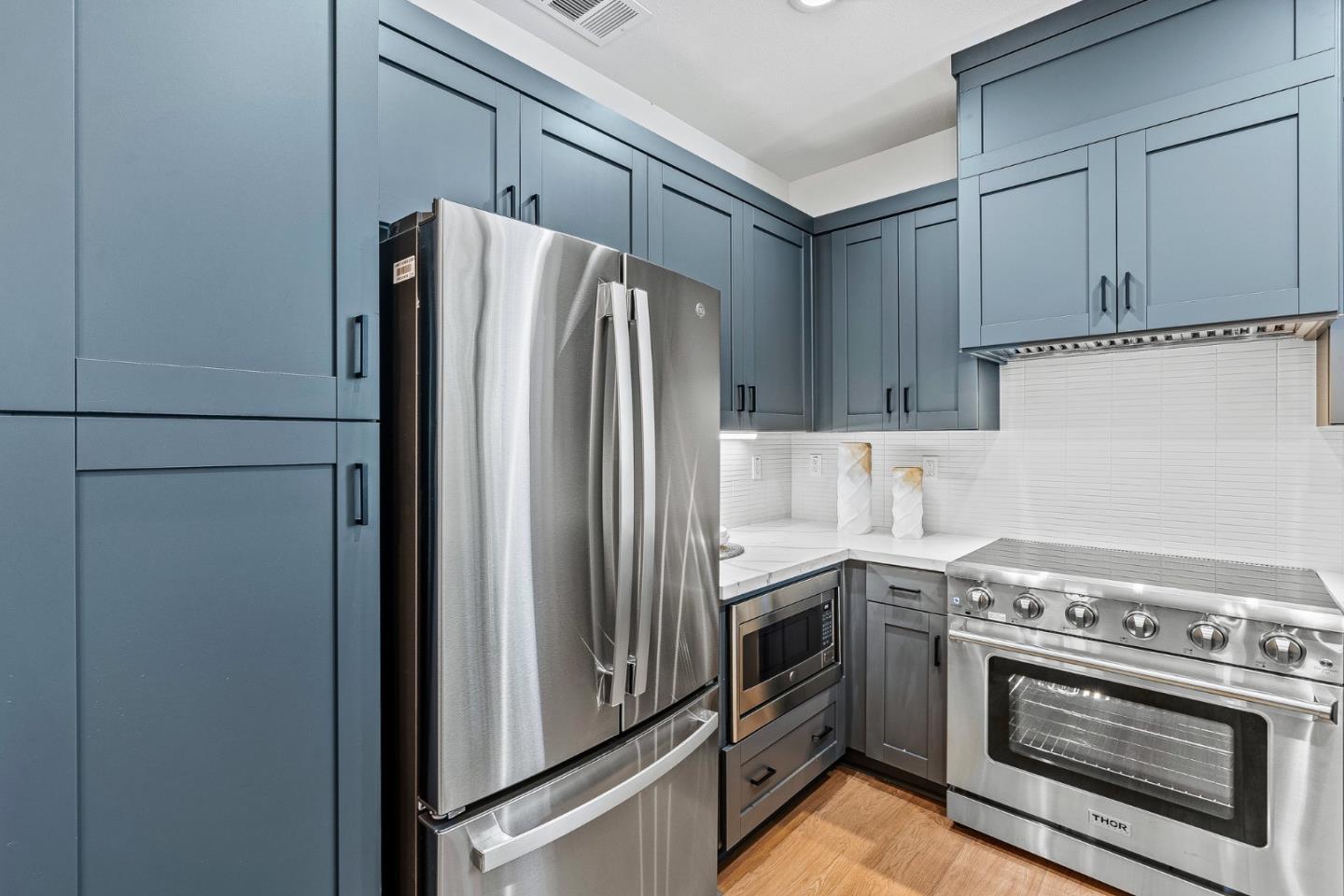 943 Woodside Road Redwood City, CA 94061 - Photo 10 of 19 a kitchen with stainless steel appliances granite countertop a refrigerator sink and stove