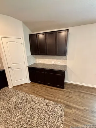 a view of wooden floor and entryway in a room