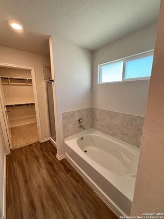 a bathroom with a bathtub and a sink