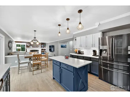 a kitchen with kitchen island a sink stove and refrigerator
