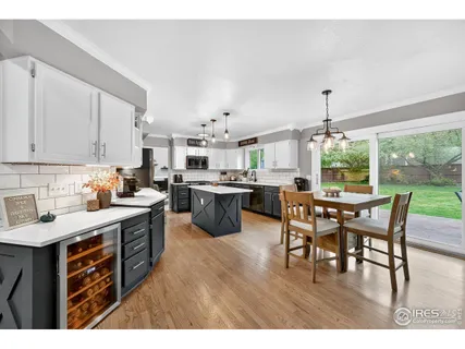 a open kitchen with stainless steel appliances kitchen island granite countertop a sink table and chairs