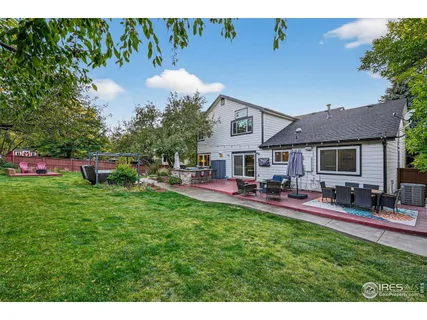 a view of a house with backyard sitting area and garden