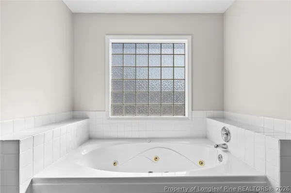 a bathroom with a bathtub and window