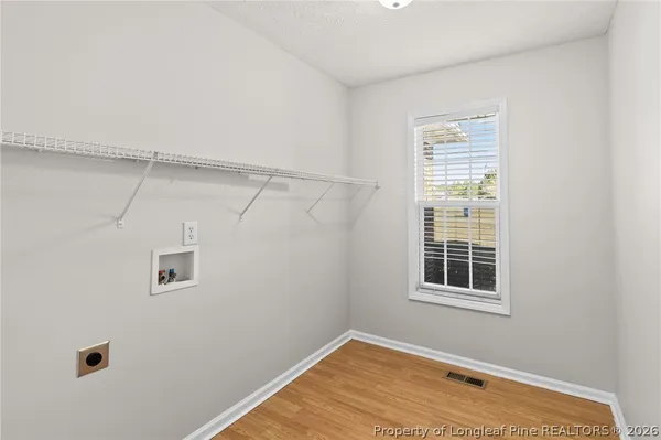 a view of a room with rack on the wall and a window