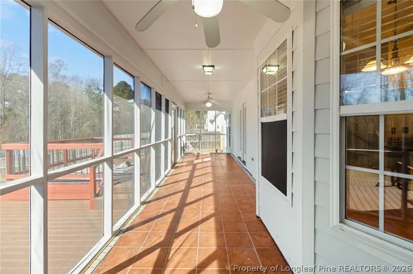 a view of a hallway with wooden floor and door
