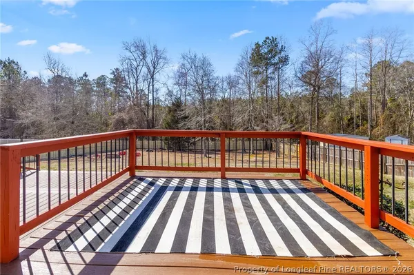 a view of balcony with wooden floor and fence