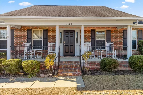 a view of front door of house with outdoor seating