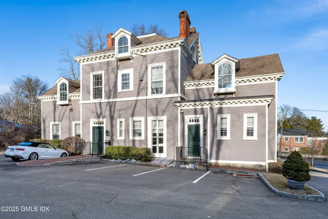 a front view of a building with parking space