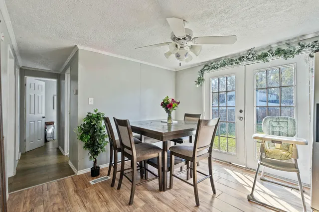 a view of a dining room with furniture and wooden floor