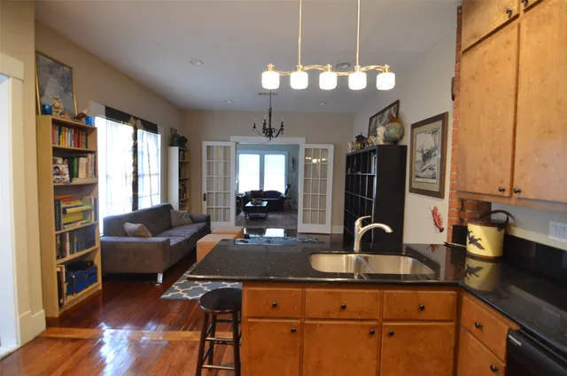 a living room with furniture and a chandelier