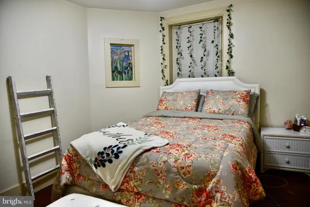 a bedroom with a bed and cabinet