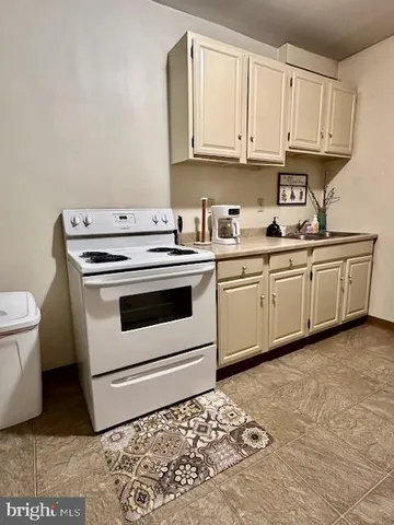a kitchen with granite countertop a sink and a stove