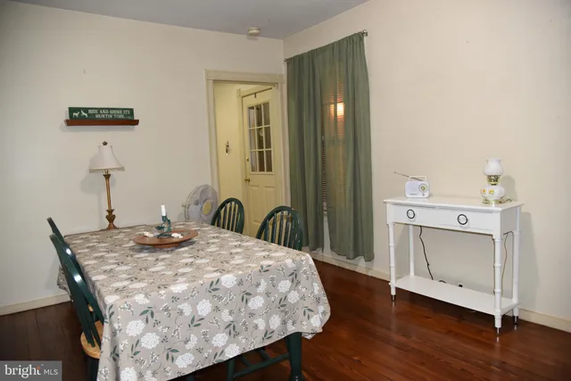 a bed sitting in a spacious bedroom next to a bathroom sink