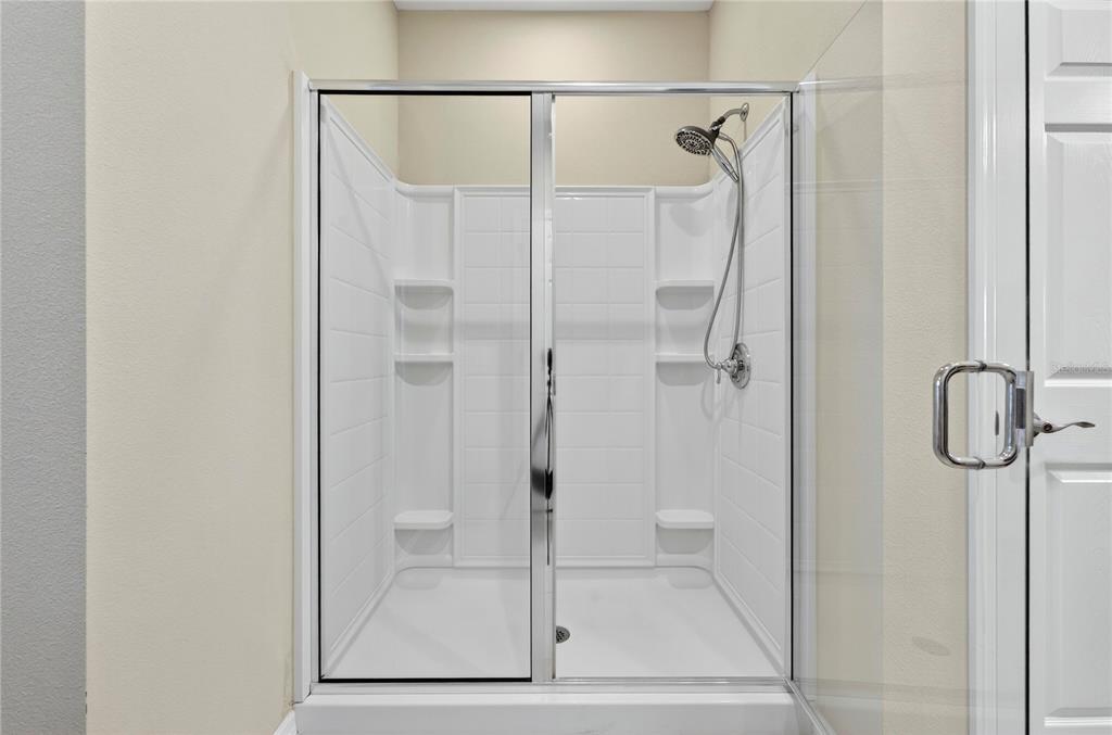 3947 Northwest 46th Ter. Ocala, FL 34482 - Photo 25 of 75 a bathroom with a glass shower door