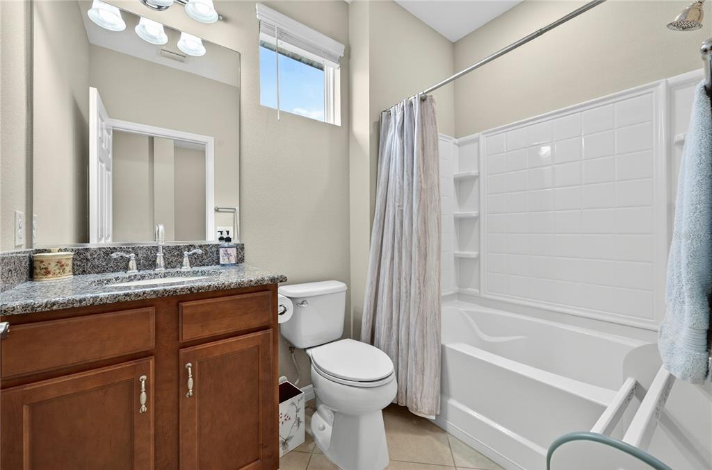 3947 Northwest 46th Ter. Ocala, FL 34482 - Photo 31 of 75 a bathroom with a granite countertop toilet sink and mirror