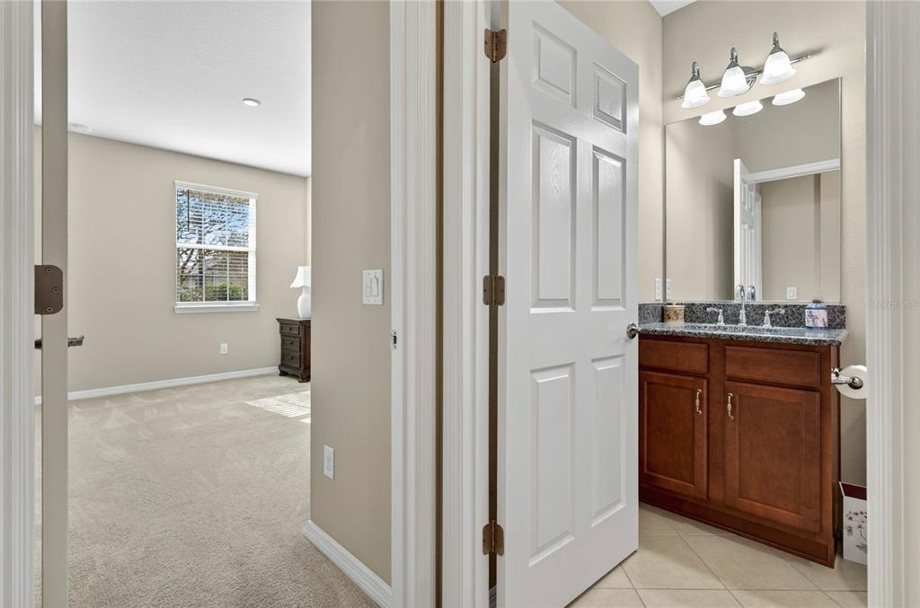 3947 Northwest 46th Ter. Ocala, FL 34482 - Photo 32 of 75 a bathroom with a granite countertop sink two mirror and a window