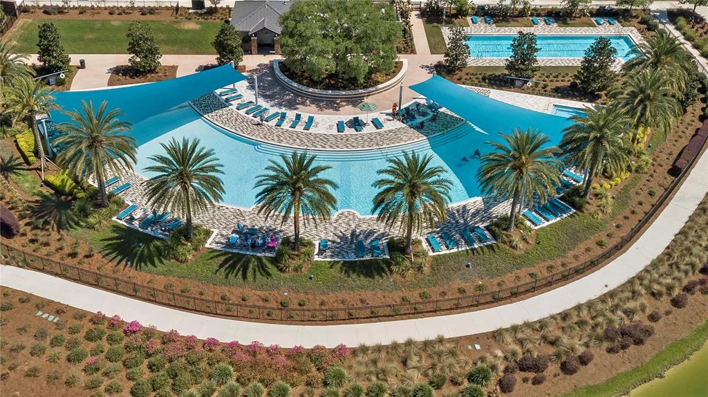 3947 Northwest 46th Ter. Ocala, FL 34482 - Photo 70 of 75 a view of a swimming pool with an outdoor seating and a lake view