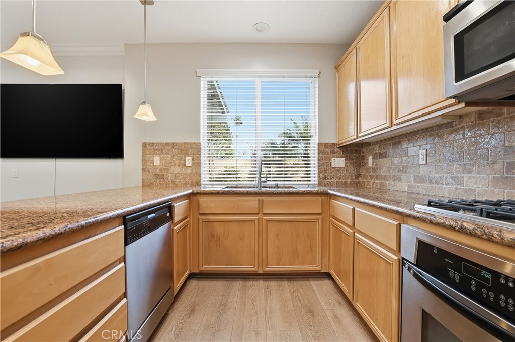 8220 Chamberlain Reseda, CA 91335 - Photo 11 of 46 a kitchen with granite countertop cabinets stainless steel appliances and a sink