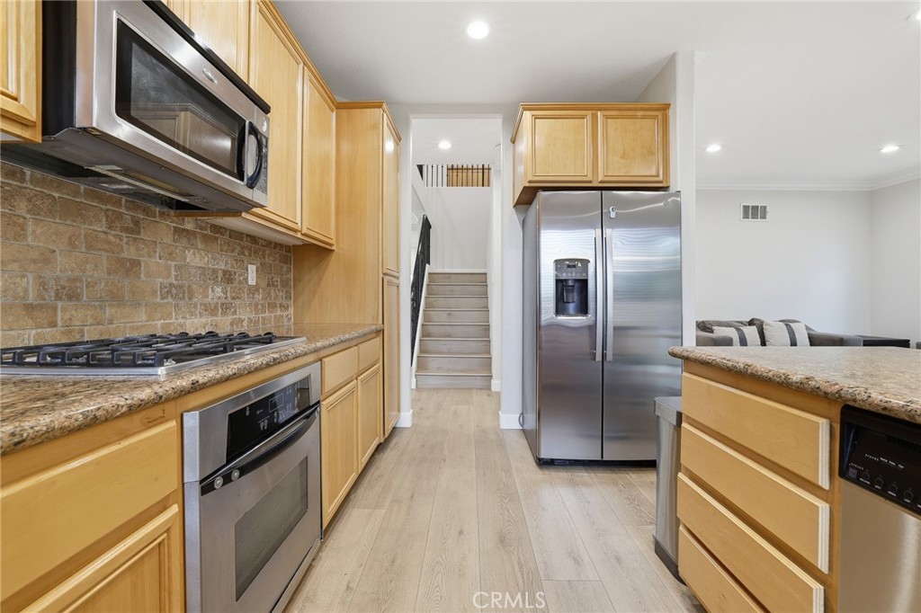8220 Chamberlain Reseda, CA 91335 - Photo 19 of 46 a kitchen with stainless steel appliances granite countertop a stove a refrigerator and a microwave