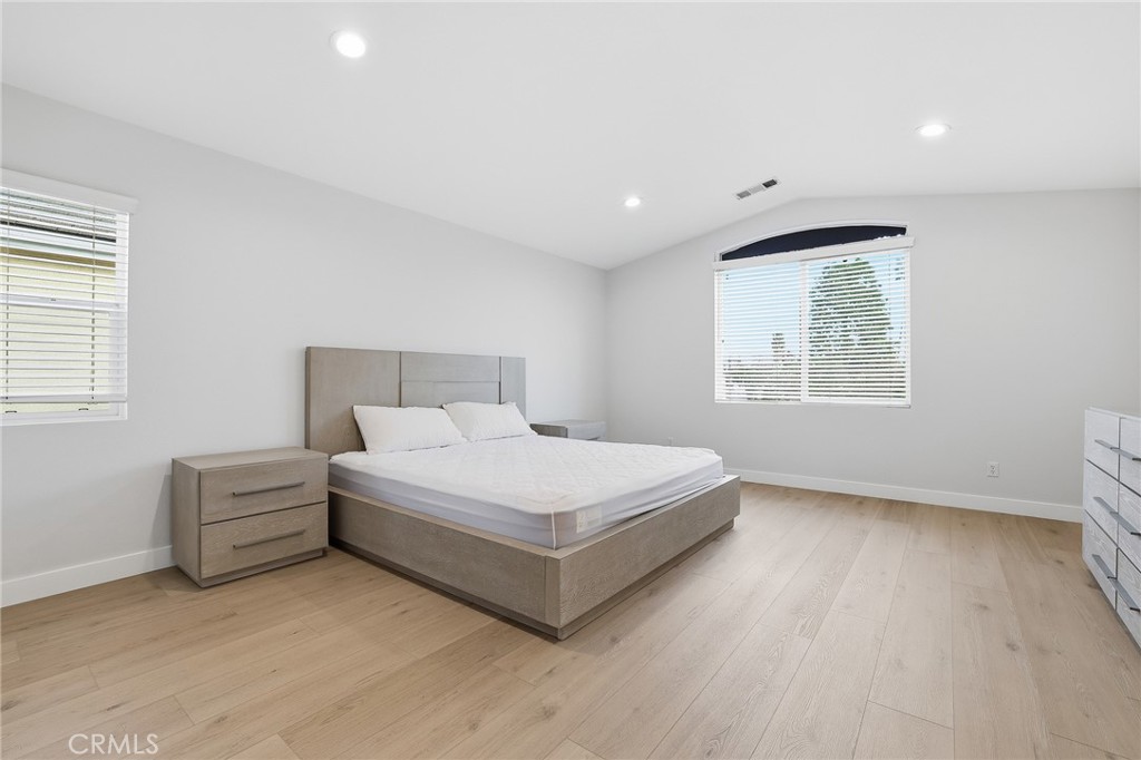 8220 Chamberlain Reseda, CA 91335 - Photo 23 of 46 a white bed sitting in a room next to a window