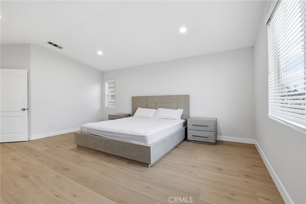 8220 Chamberlain Reseda, CA 91335 - Photo 24 of 46 a spacious bedroom with a bed and a window