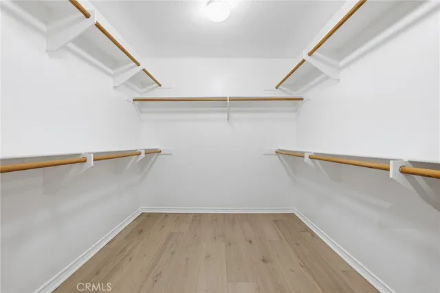 a white toilet sitting next to a white wall