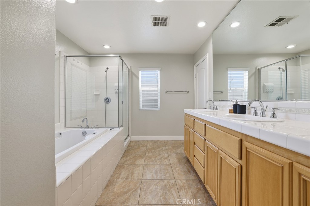 8220 Chamberlain Reseda, CA 91335 - Photo 28 of 46 a spacious bathroom with a double vanity sink a mirror and a bathtub