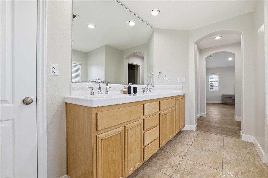 8220 Chamberlain Reseda, CA 91335 - Photo 30 of 46 a en suite bathroom with a double vanity sink a mirror and a