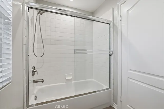 a view of a patio with table and chairs and potted plants with wooden fence