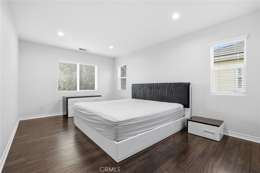 8220 Chamberlain Reseda, CA 91335 - Photo 37 of 46 a large bed sitting in a room next to a window