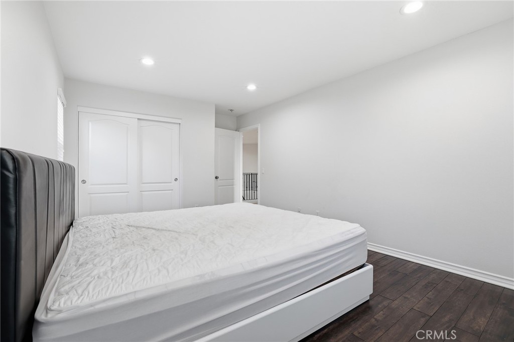 8220 Chamberlain Reseda, CA 91335 - Photo 38 of 46 a bedroom with a bed and wooden floor