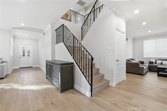 a kitchen with stainless steel appliances granite countertop a sink and a stove with wooden floor