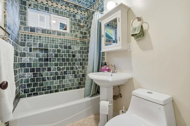 a bathroom with a sink a toilet and bathtub