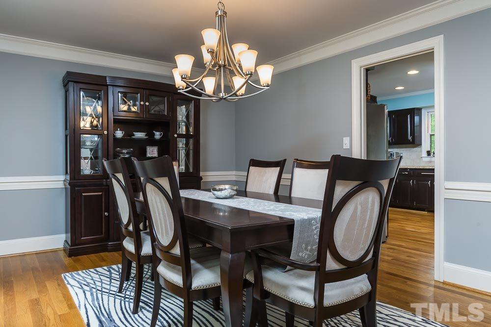 717 Bennington Drive Raleigh, NC 27615 - Photo 2 of 25 a view of a dining room with furniture wooden floor and chandelier