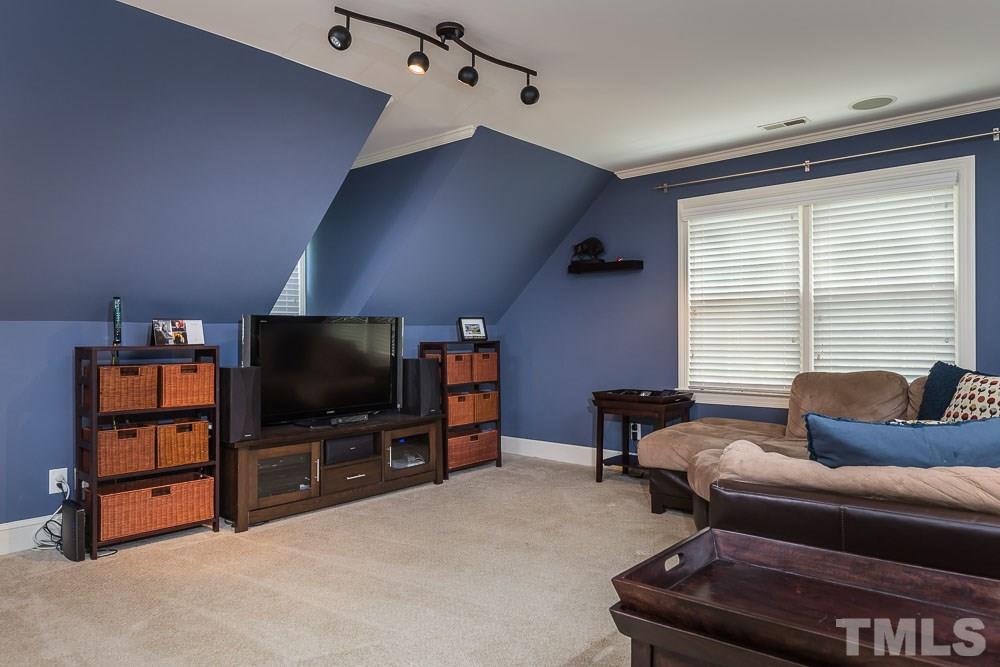 717 Bennington Drive Raleigh, NC 27615 - Photo 12 of 25 a living room with furniture and a flat screen tv