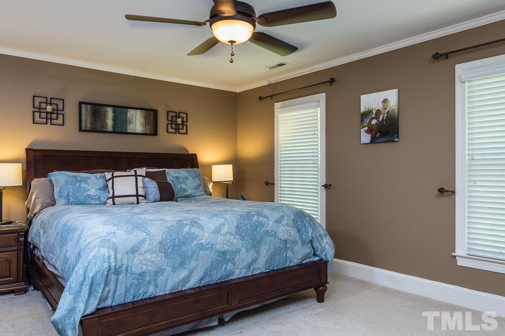 717 Bennington Drive Raleigh, NC 27615 - Photo 15 of 25 a bedroom with a bed and window