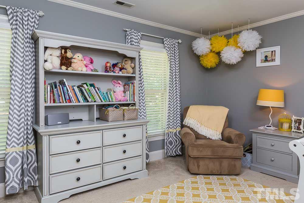 717 Bennington Drive Raleigh, NC 27615 - Photo 17 of 25 a living room with furniture and painting on the wall