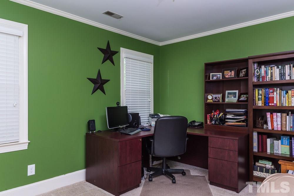 717 Bennington Drive Raleigh, NC 27615 - Photo 19 of 25 a view of a workspace with furniture and a bookshelf
