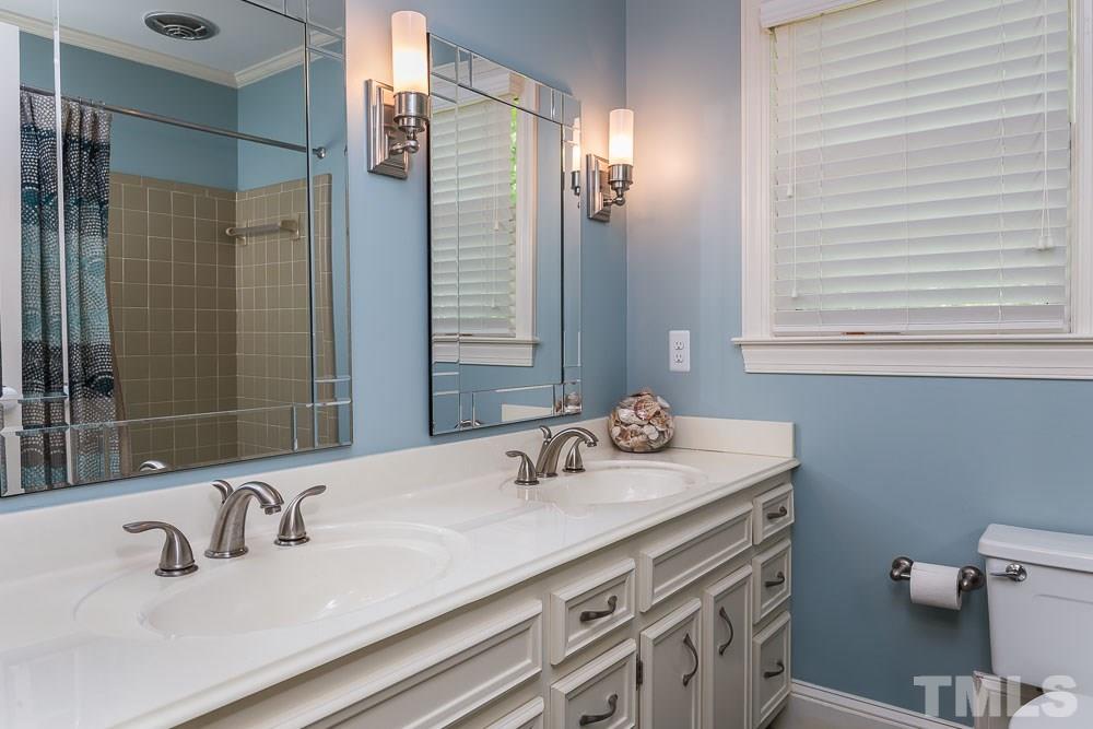 717 Bennington Drive Raleigh, NC 27615 - Photo 20 of 25 a bathroom with a sink and a mirror