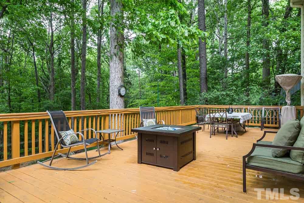 717 Bennington Drive Raleigh, NC 27615 - Photo 23 of 25 a view of a roof deck with a couple of couches and wooden fence