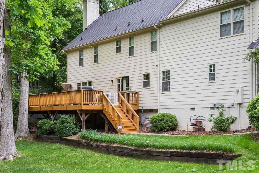 717 Bennington Drive Raleigh, NC 27615 - Photo 24 of 25 a view of a house with a small yard and plants