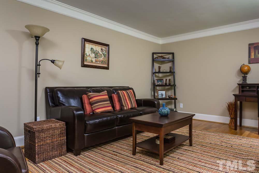 717 Bennington Drive Raleigh, NC 27615 - Photo 4 of 25 a living room with furniture and a wooden floor
