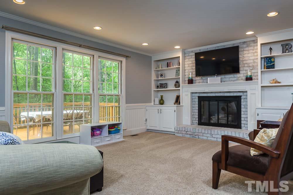 717 Bennington Drive Raleigh, NC 27615 - Photo 9 of 25 a living room with furniture fireplace and flat screen tv