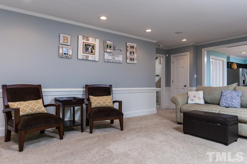 717 Bennington Drive Raleigh, NC 27615 - Photo 10 of 25 a living room with furniture and a piano
